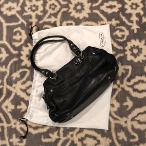 All black leather Coach bag with bag slip